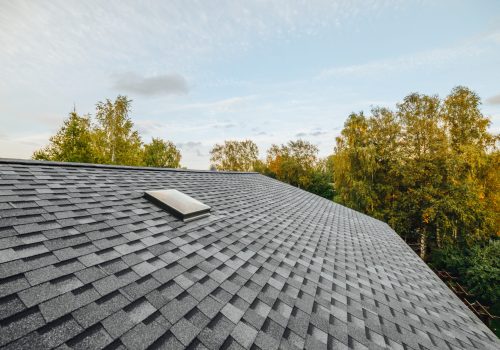 new renovated roof covered with shingles flat polymeric roof-tiles